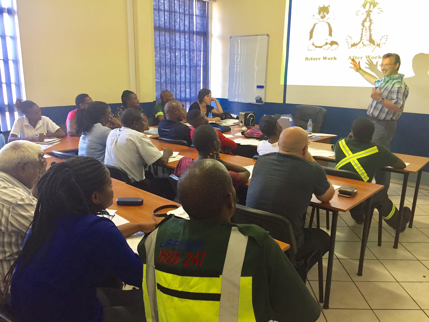 An OSH-Med instructor teaching a full classroom